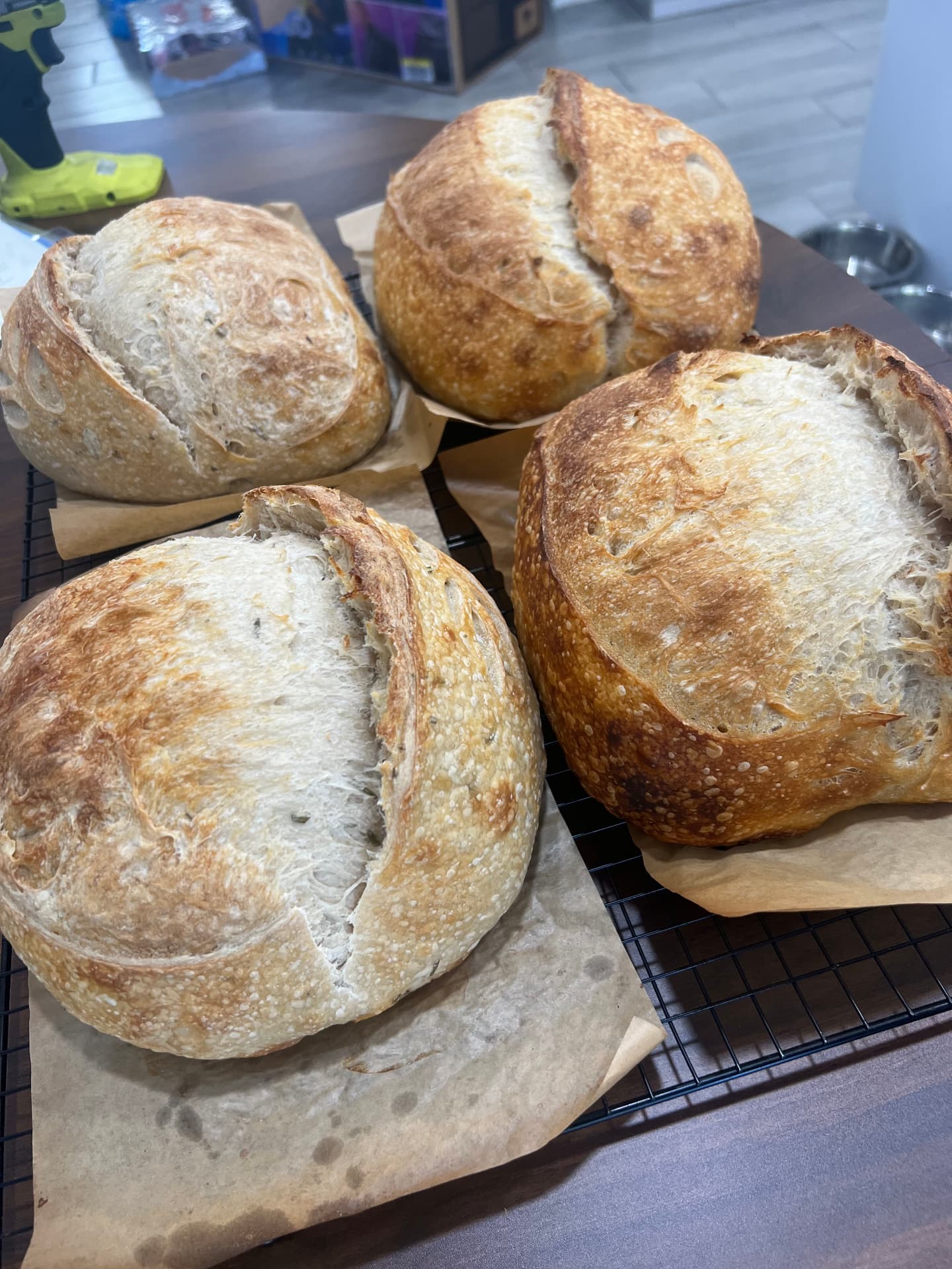 Four rustic sourdough loaves with blistered crusts